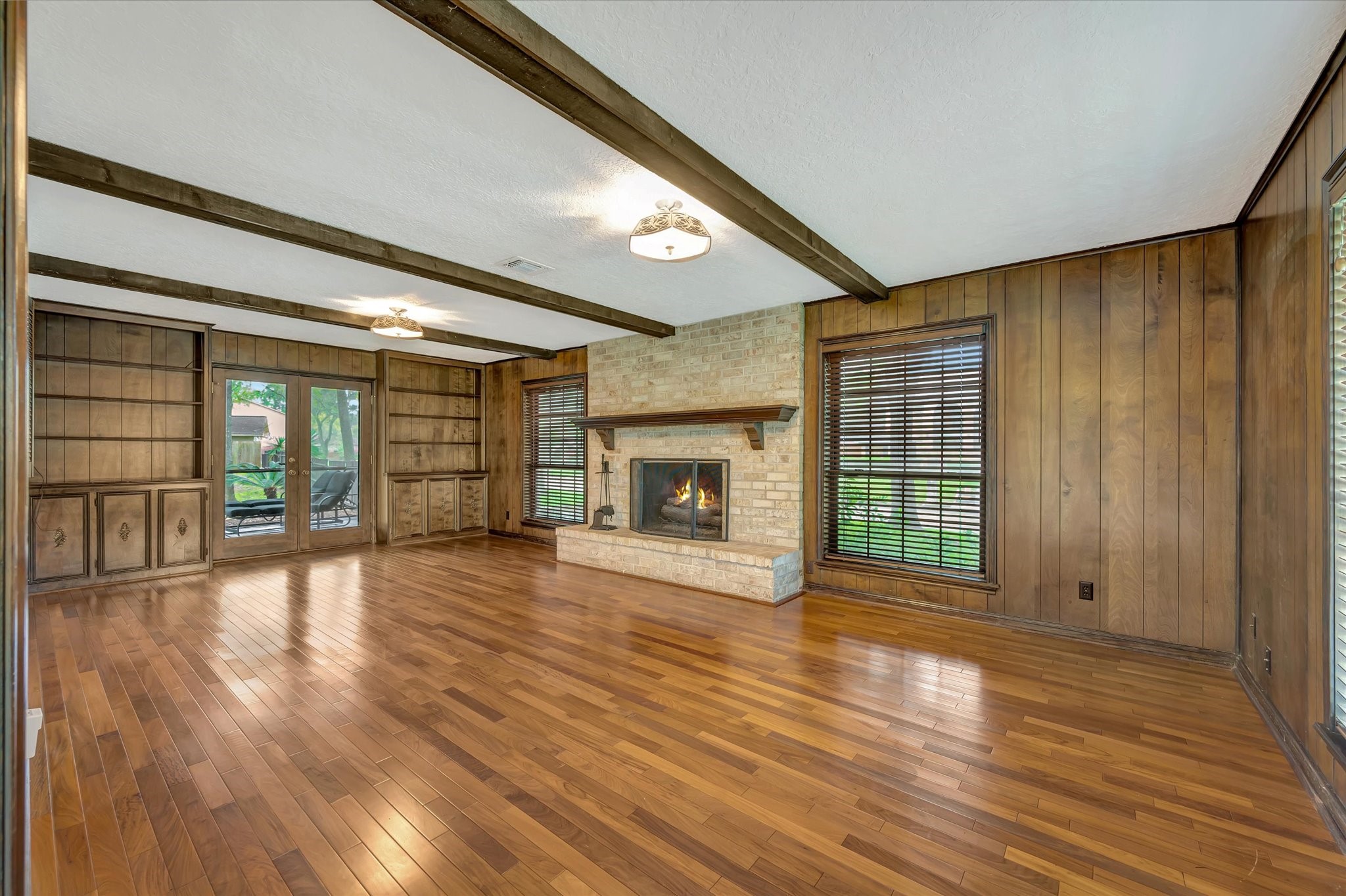 822 Devonport Lane Seabrook, TX 77586 - Photo 19 of 50 a view of an empty room with wooden floor and a window