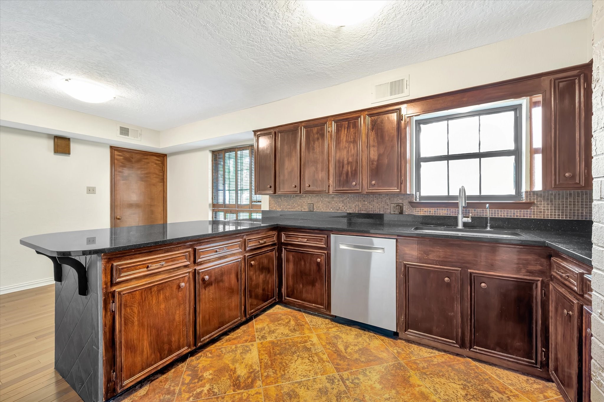 822 Devonport Lane Seabrook, TX 77586 - Photo 24 of 50 a kitchen with granite countertop sink stove and cabinets
