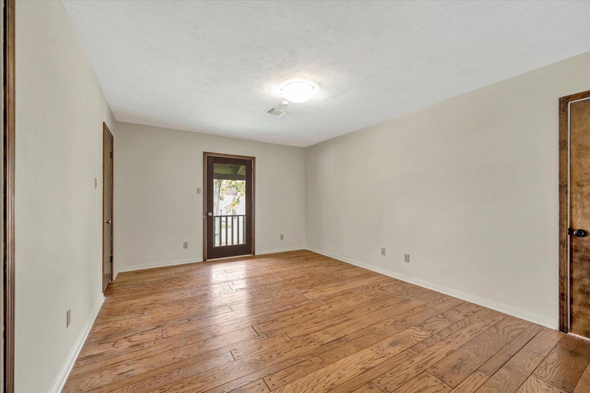 822 Devonport Lane Seabrook, TX 77586 - Photo 33 of 50 a view of an empty room with wooden floor and a window