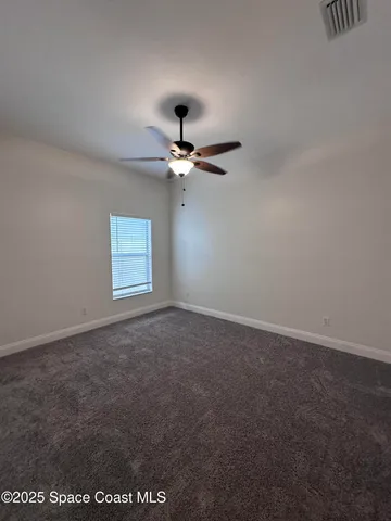 a view of a ceiling fan and hardwood floor