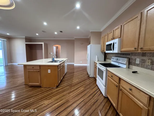 a large kitchen with stainless steel appliances granite countertop a large stove a sink dishwasher and a refrigerator