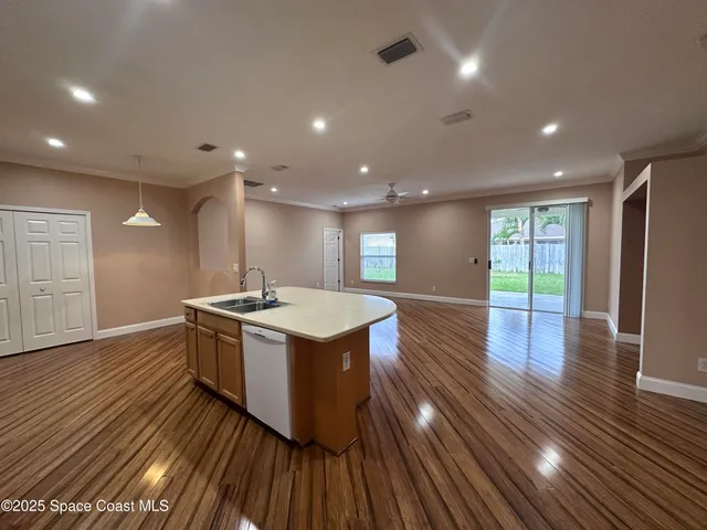 a kitchen with stainless steel appliances granite countertop a stove and a wooden floors