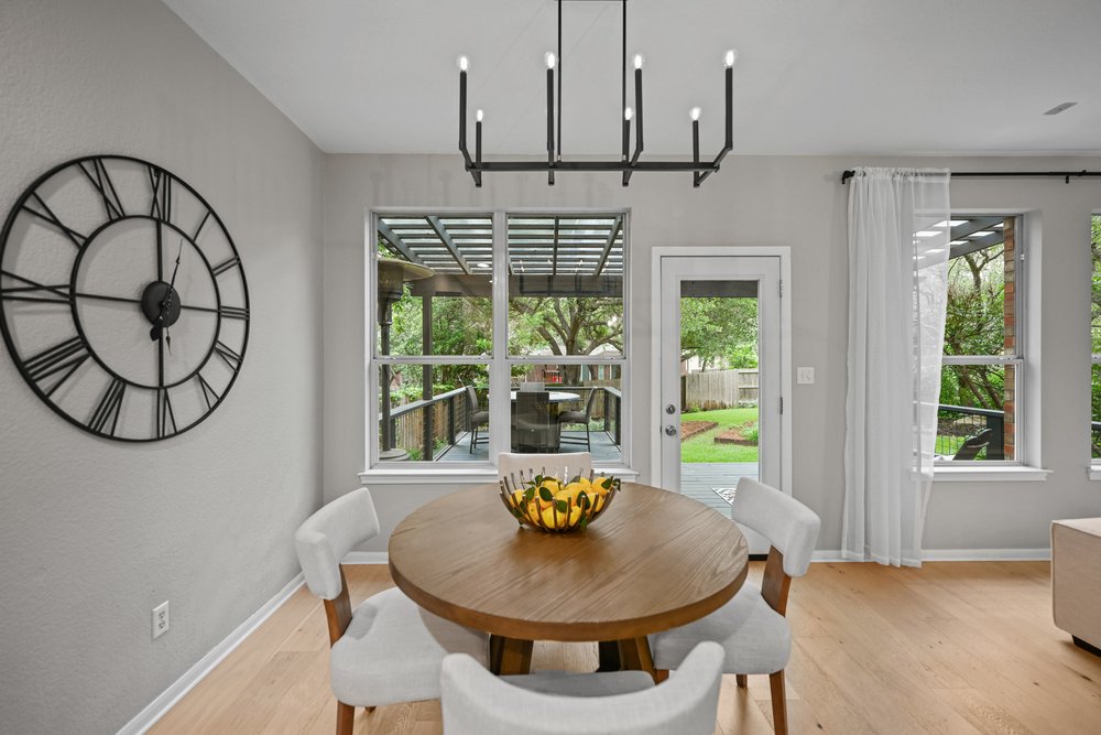 2823 Lantana Ridge Drive Austin, TX 78732 - Photo 14 of 34 a view of a dining room with furniture window and wooden floor