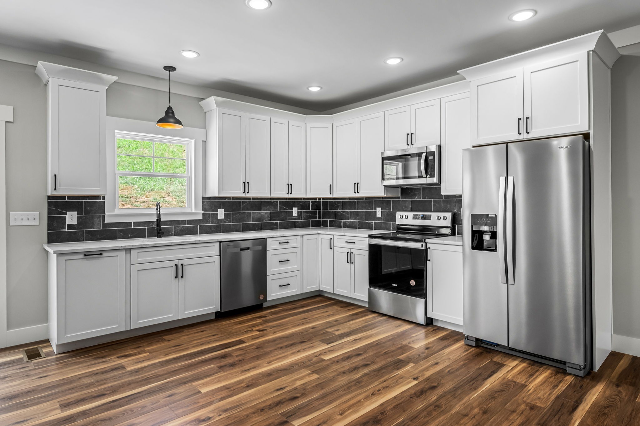 2305 Hurricane Creek Road Lynchburg, TN 37352 - Photo 12 of 54 a kitchen with granite countertop white cabinets and stainless steel appliances