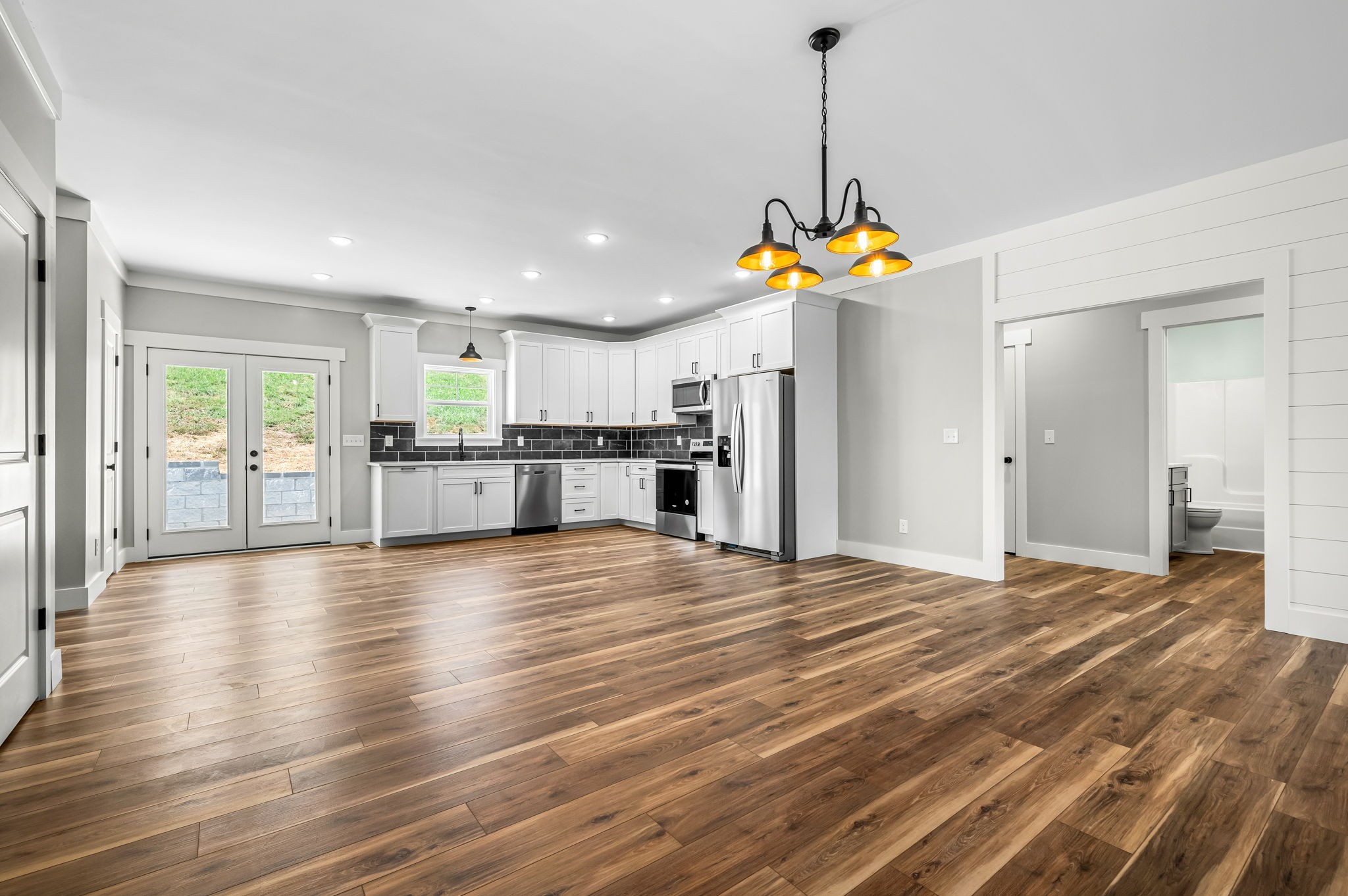 2305 Hurricane Creek Road Lynchburg, TN 37352 - Photo 17 of 54 a view of a kitchen with a refrigerator wooden floor and a kitchen space