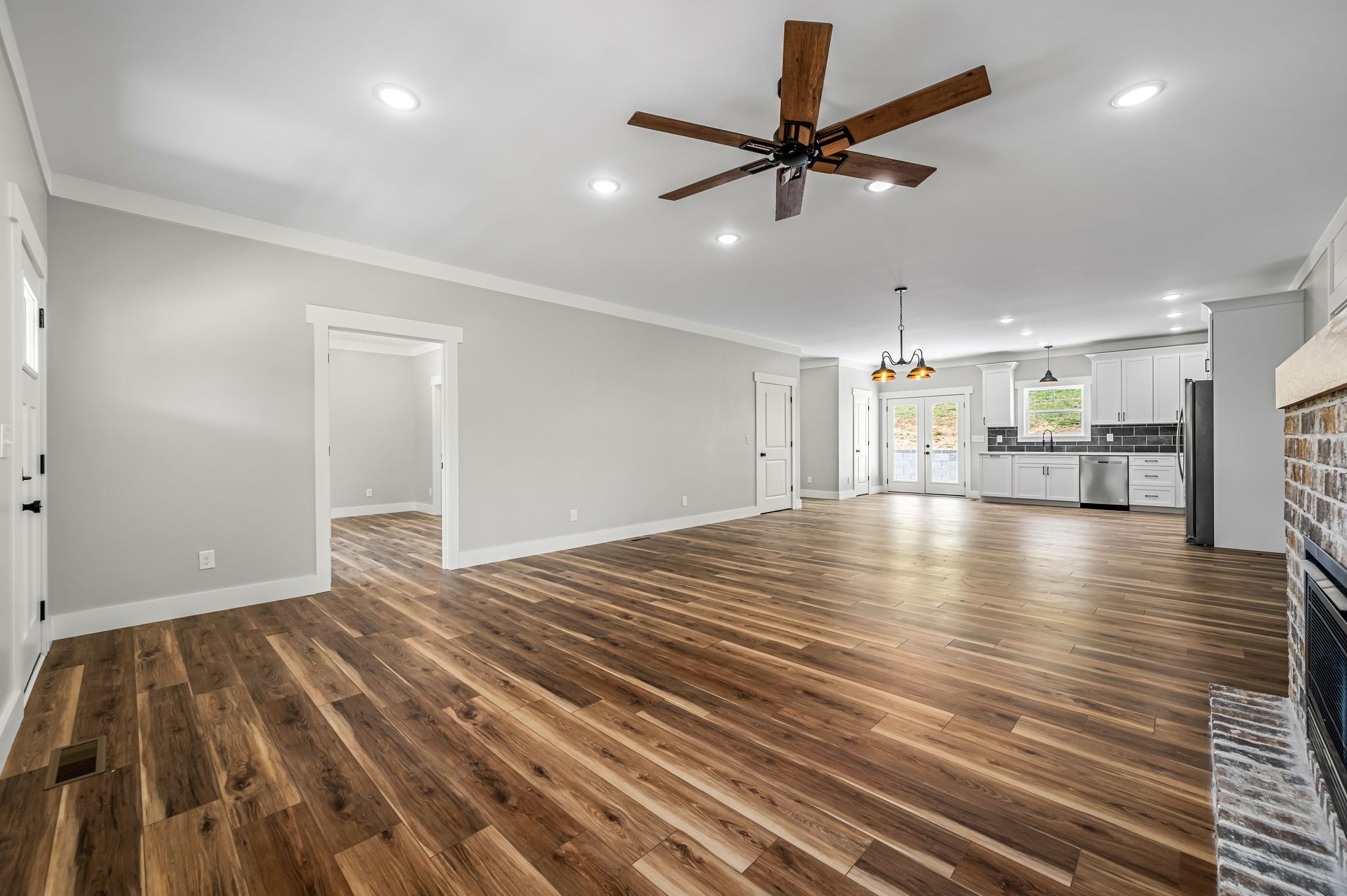 2305 Hurricane Creek Road Lynchburg, TN 37352 - Photo 25 of 54 a view of a livingroom with a ceiling fan and wooden floor