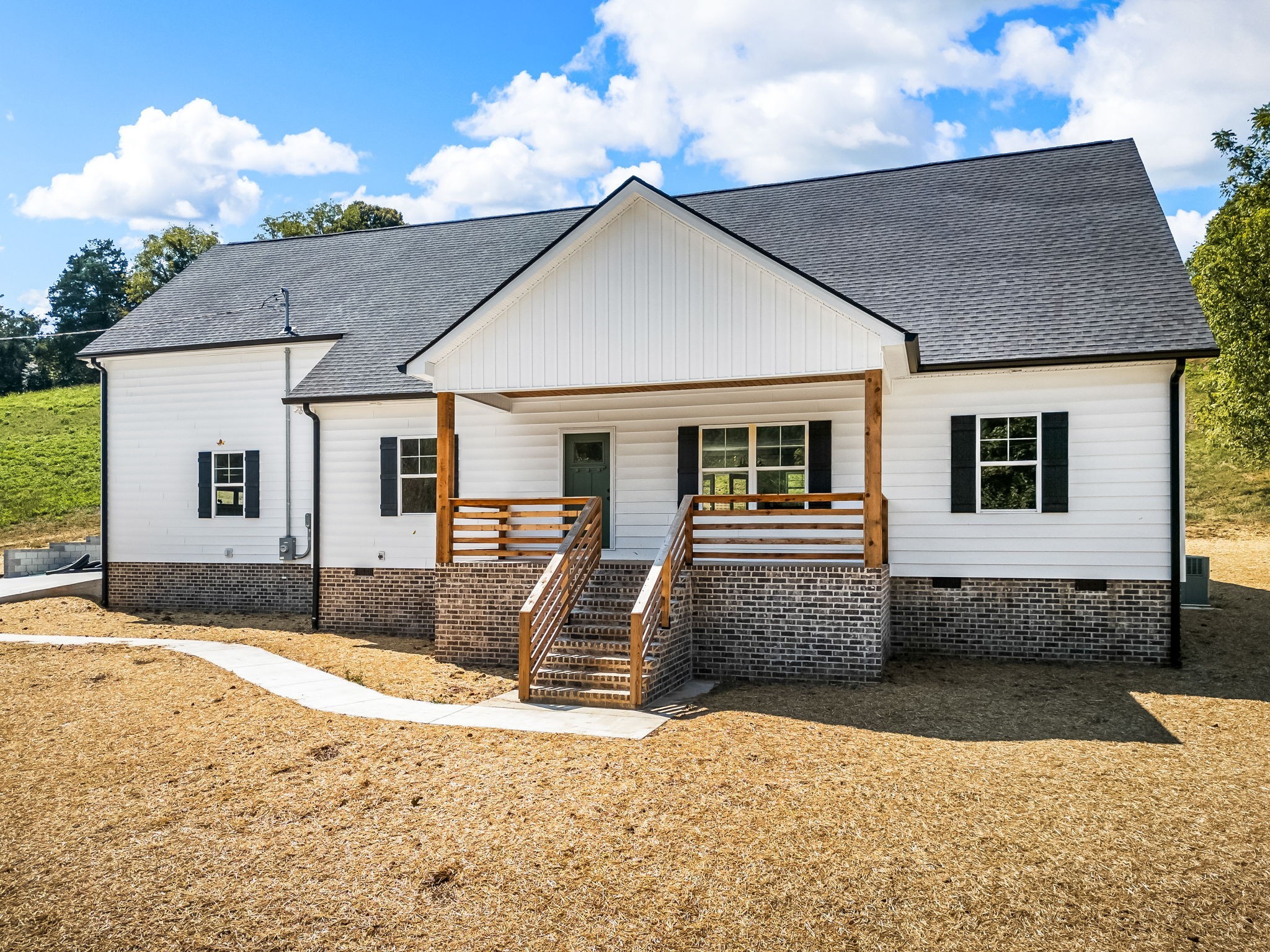 2305 Hurricane Creek Road Lynchburg, TN 37352 - Photo 6 of 54 a front view of a house with a yard and garage