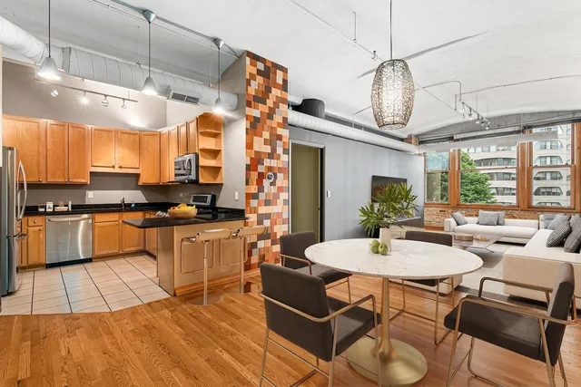 a kitchen with a table chairs stove and cabinets