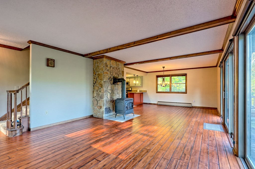 206 Peckerwood Road Hayesville, NC 28904 - Photo 12 of 73 a view of empty room with wooden floor and fan