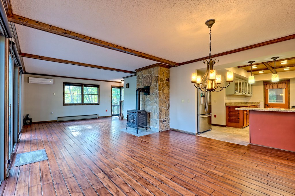 206 Peckerwood Road Hayesville, NC 28904 - Photo 19 of 73 a view of a living room with wooden floor and a ceiling fan