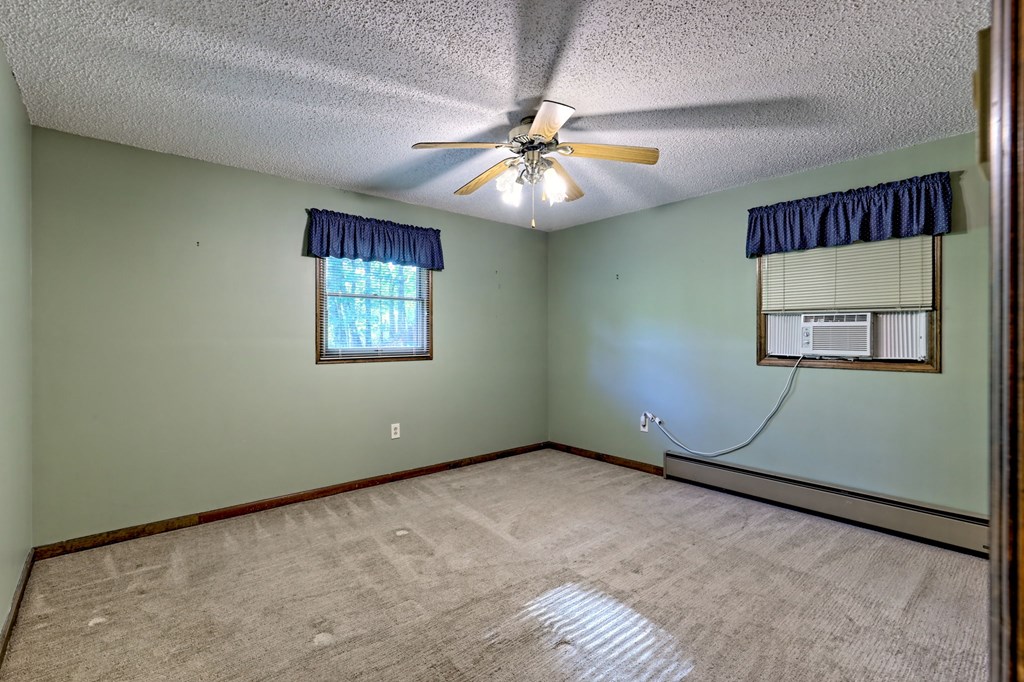 206 Peckerwood Road Hayesville, NC 28904 - Photo 23 of 73 an empty room with windows and fan