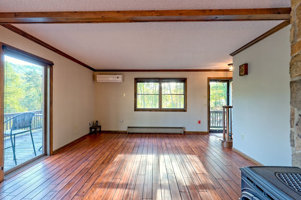 206 Peckerwood Road Hayesville, NC 28904 - Photo 26 of 73 a view of an empty room with wooden floor and a window