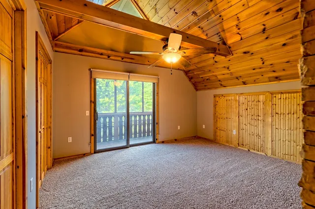 a room with a bed and a large window