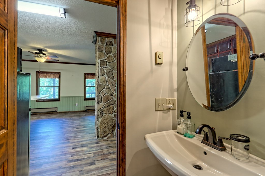 206 Peckerwood Road Hayesville, NC 28904 - Photo 49 of 73 a bathroom with a sink and a mirror