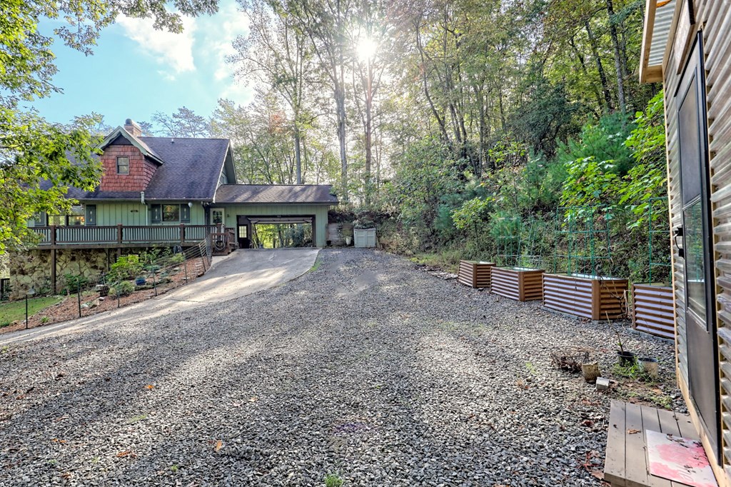 206 Peckerwood Road Hayesville, NC 28904 - Photo 58 of 73 a view of a house with a yard and sitting area