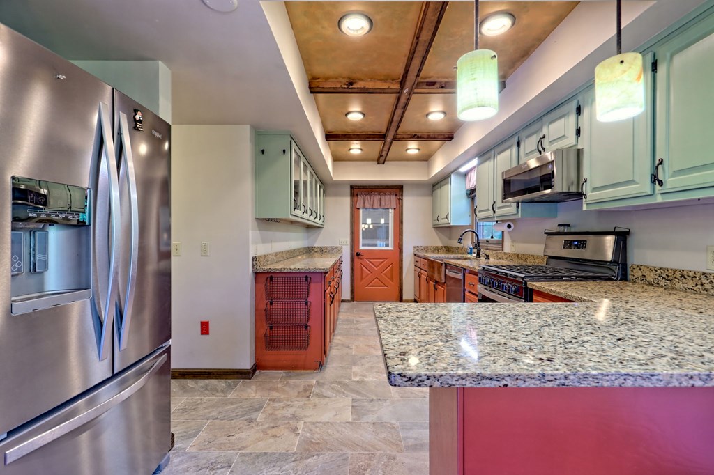 206 Peckerwood Road Hayesville, NC 28904 - Photo 10 of 73 a kitchen with stainless steel appliances granite countertop a refrigerator a stove and a sink