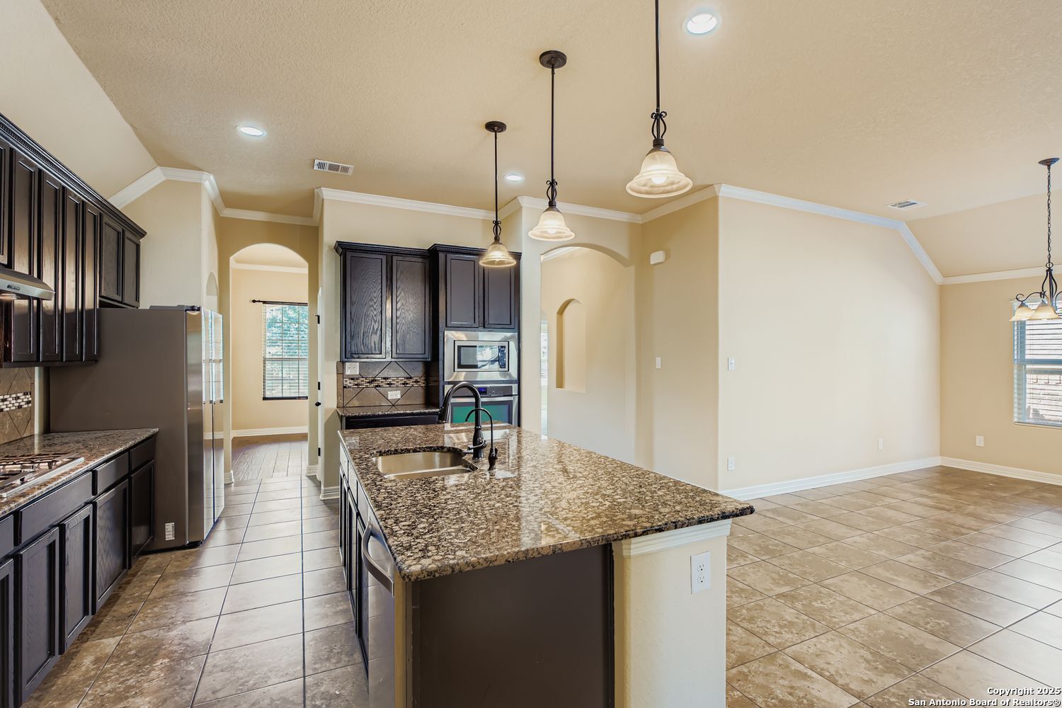 17820 Oxford Mount Helotes, TX 78023 - Photo 11 of 26 a kitchen with stainless steel appliances granite countertop a sink a oven a refrigerator and a stove