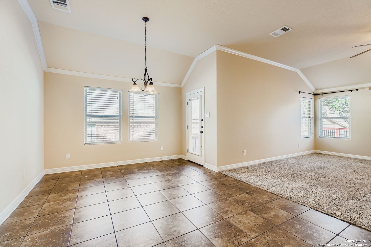 17820 Oxford Mount Helotes, TX 78023 - Photo 12 of 26 a view of an empty room with windows and kitchen view