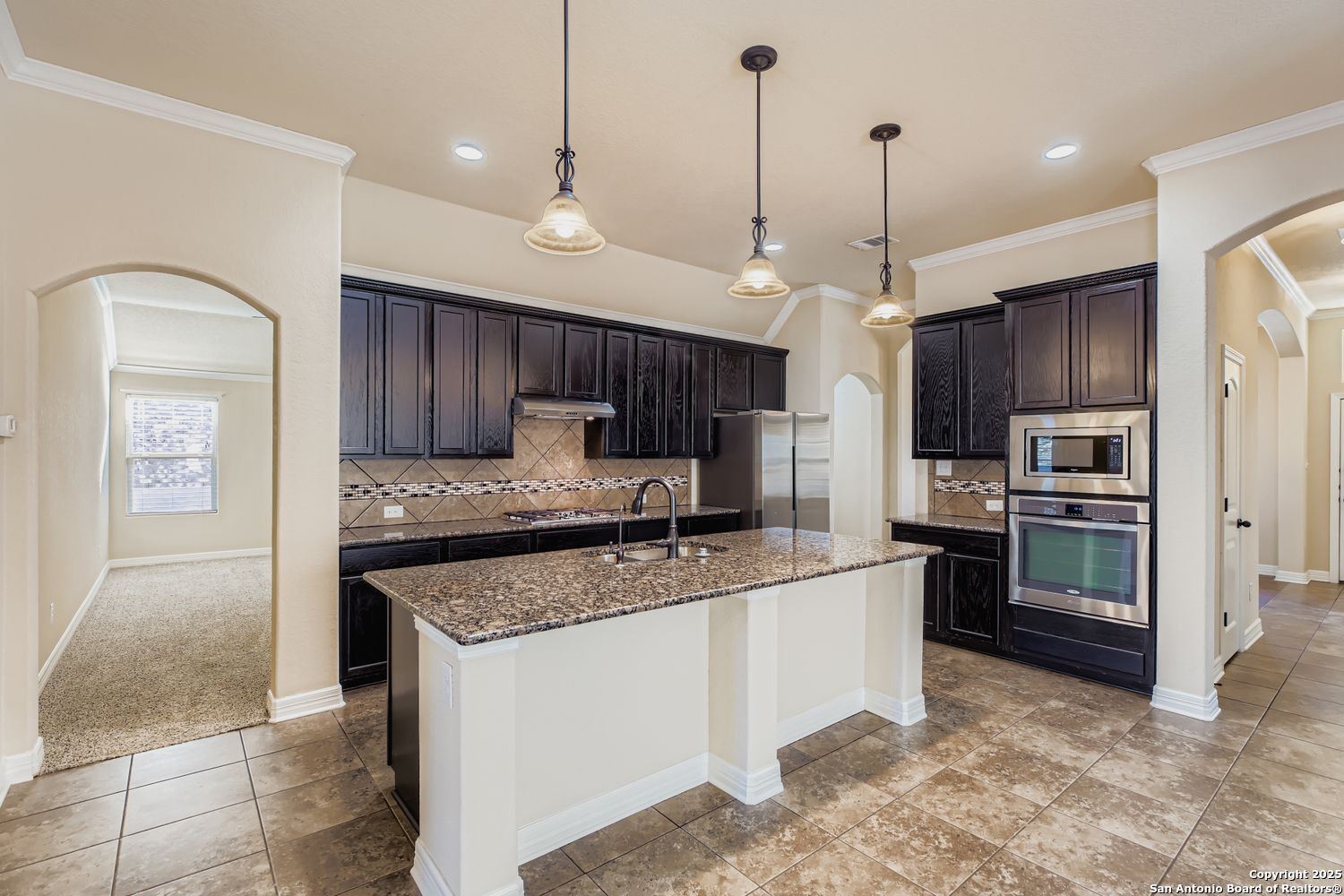 17820 Oxford Mount Helotes, TX 78023 - Photo 8 of 26 a kitchen with stainless steel appliances granite countertop a stove refrigerator sink and microwave