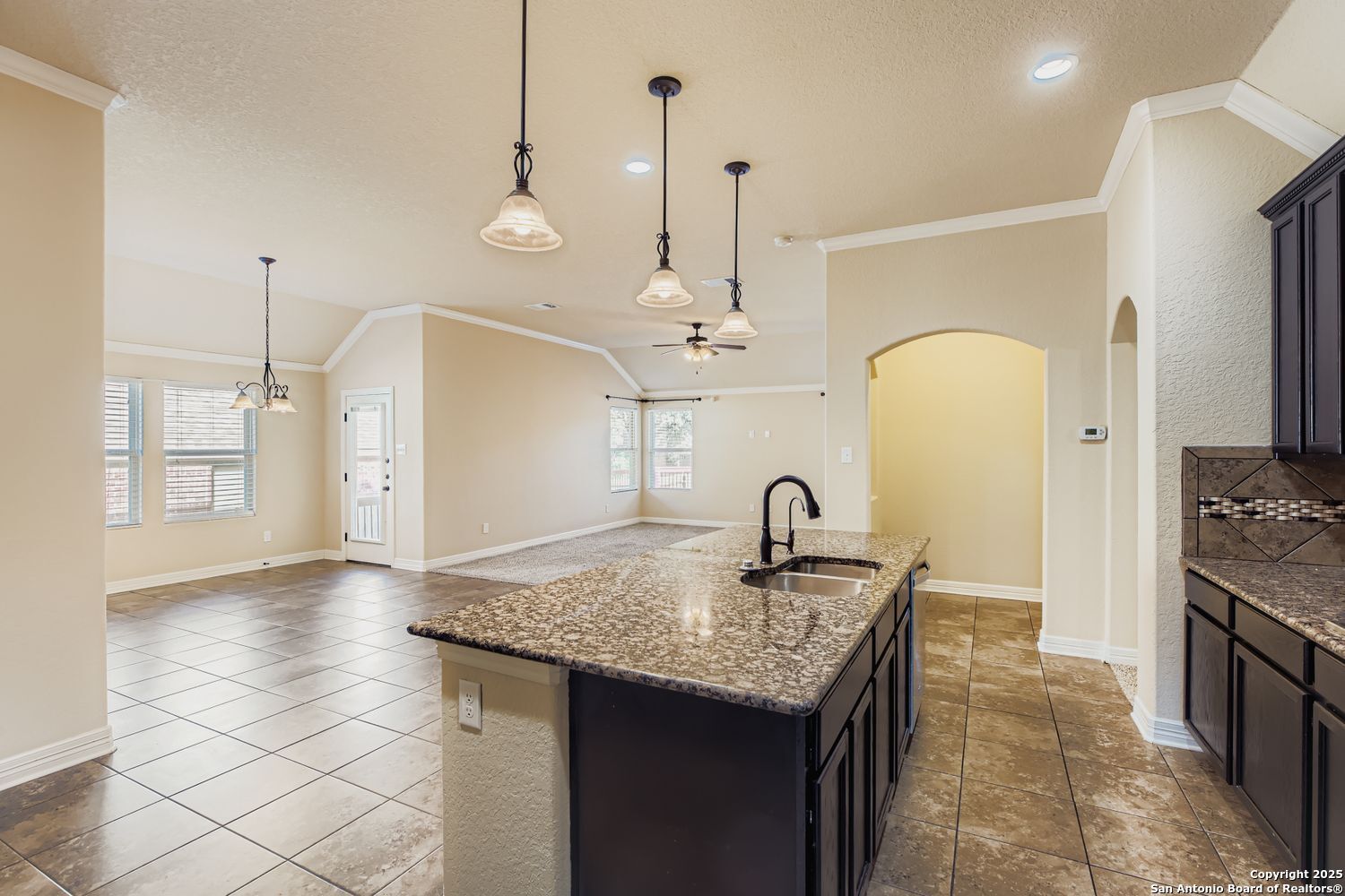 17820 Oxford Mount Helotes, TX 78023 - Photo 10 of 26 a kitchen with granite countertop a sink a stove and a refrigerator