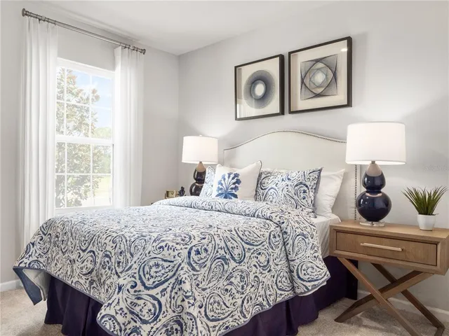 a bedroom with a bed and painting on the wall