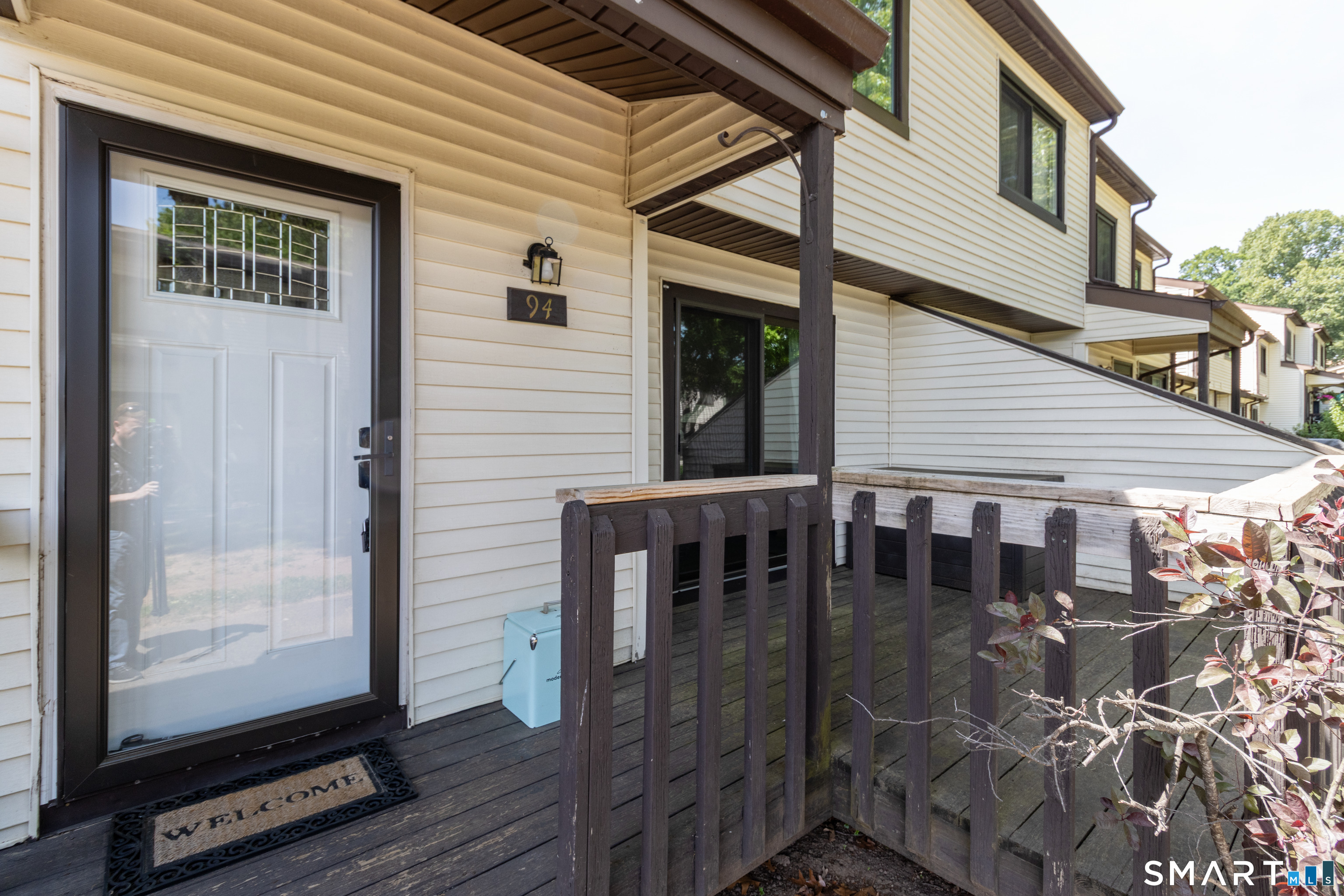 94 Cottonwood Road, Unit 94 Newington, CT 06111 - Photo 24 of 33 Front door with awning and front deck off the Dining Area facing toward garden area.
