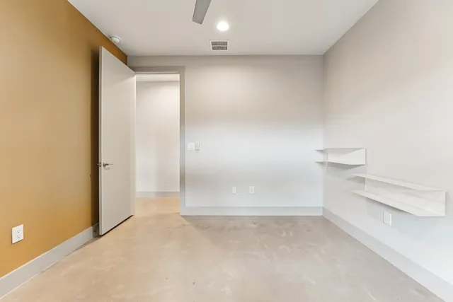 a view of a livingroom with a ceiling fan and window