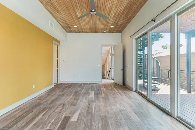 a bathroom with a sink a toilet a mirror a bathtub and window