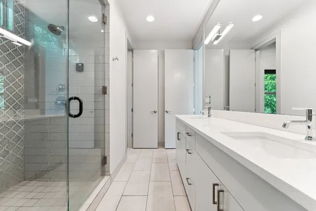 a bathroom with a sink double vanity and a mirror