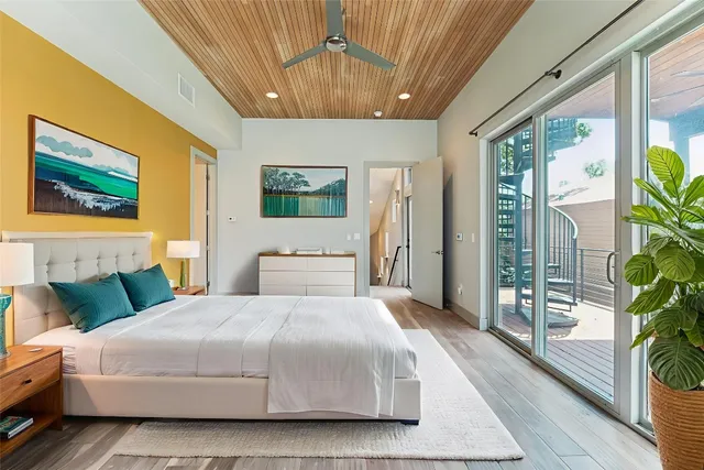 a bedroom with a large bed and a painting on the wall