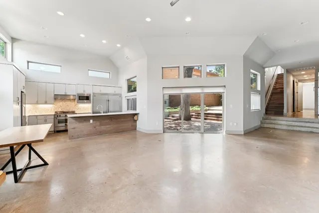 a view of a kitchen with dining table and chairs