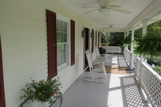 1479 Girl Scout Road Lizella, GA 31052 - Photo 22 of 25 a view of a patio with table and chairs potted plants with wooden floor and fence