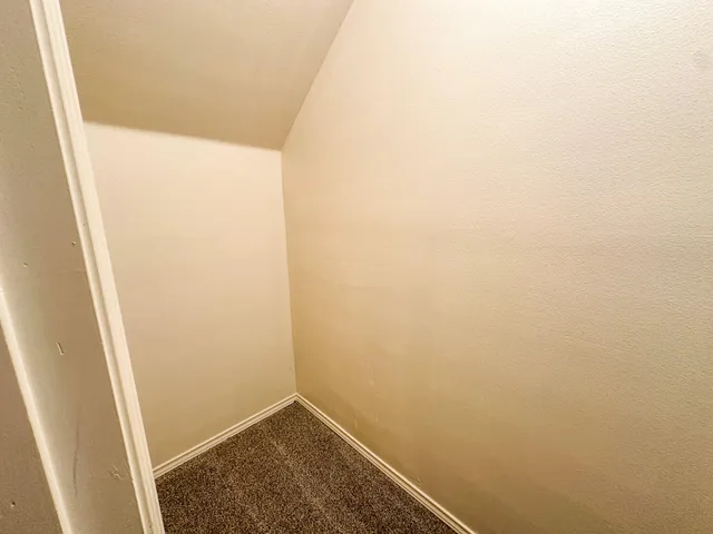 an empty room with a empty space and windows