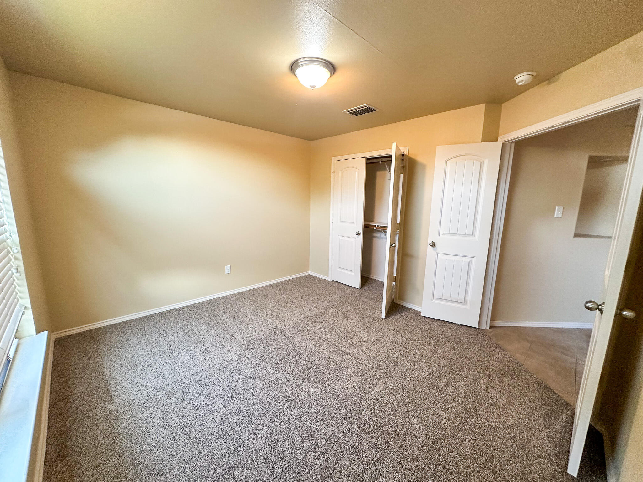 2309 101st Street Lubbock, TX 79423 - Photo 14 of 36 an empty room with closet and wooden floor