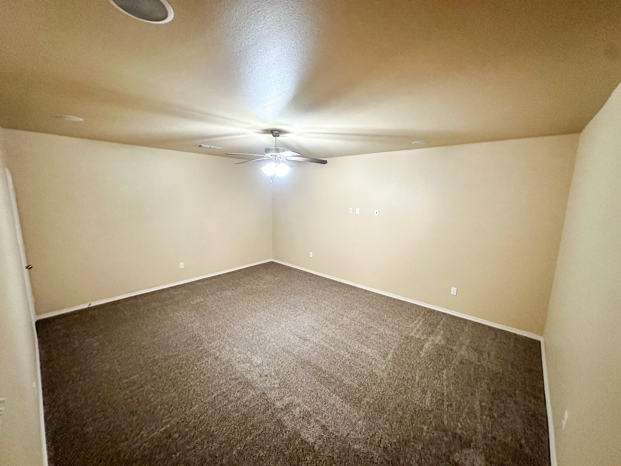2309 101st Street Lubbock, TX 79423 - Photo 16 of 36 an empty room with a ceiling fan and a window