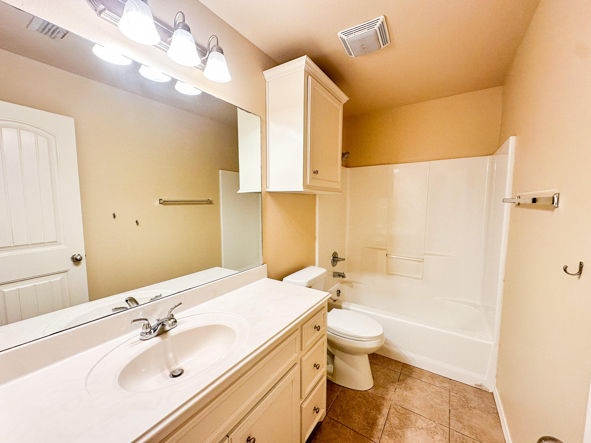 2309 101st Street Lubbock, TX 79423 - Photo 18 of 36 a bathroom with a sink a toilet and shower