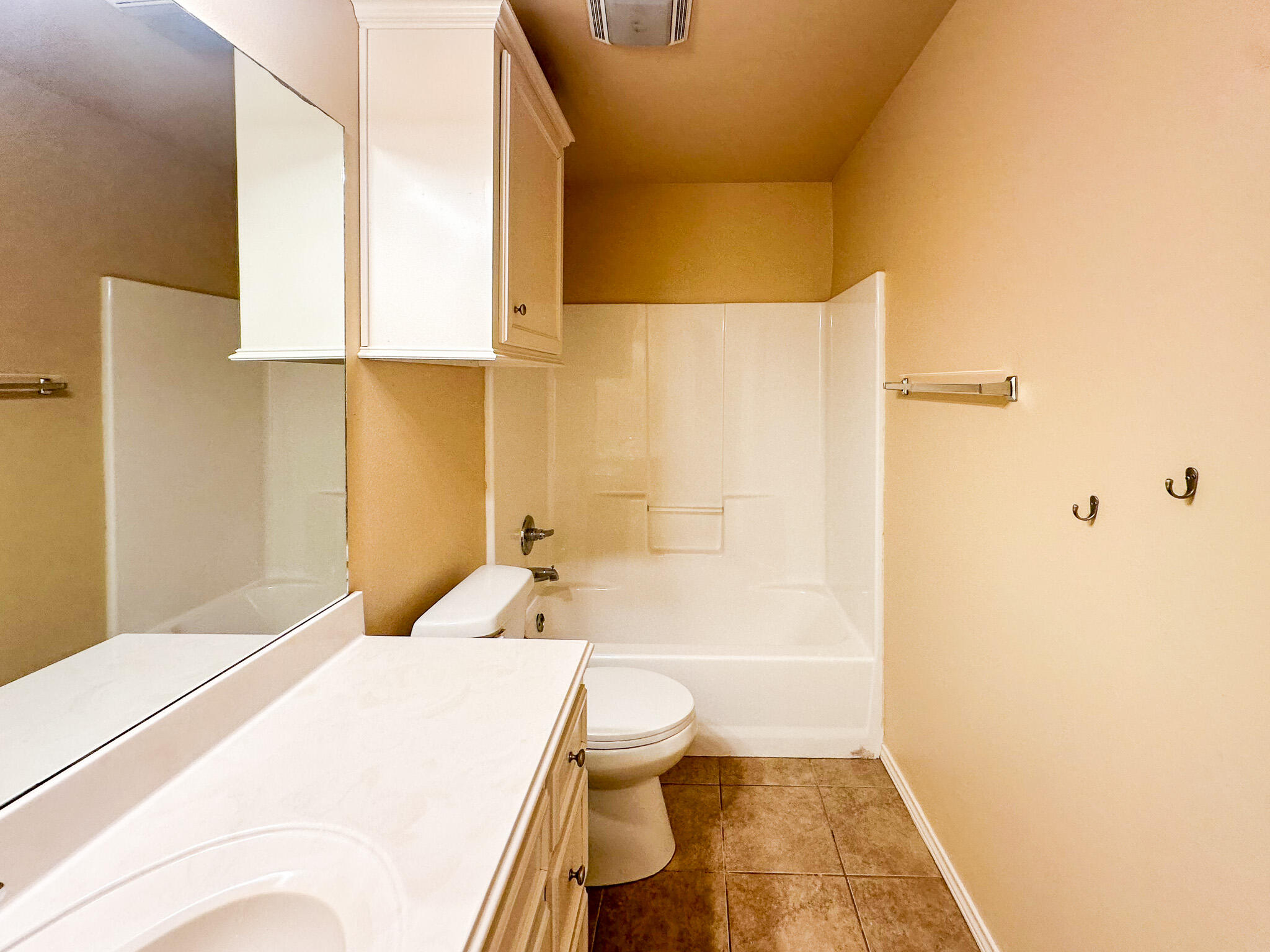 2309 101st Street Lubbock, TX 79423 - Photo 19 of 36 a bathroom with a bathtub and a toilet