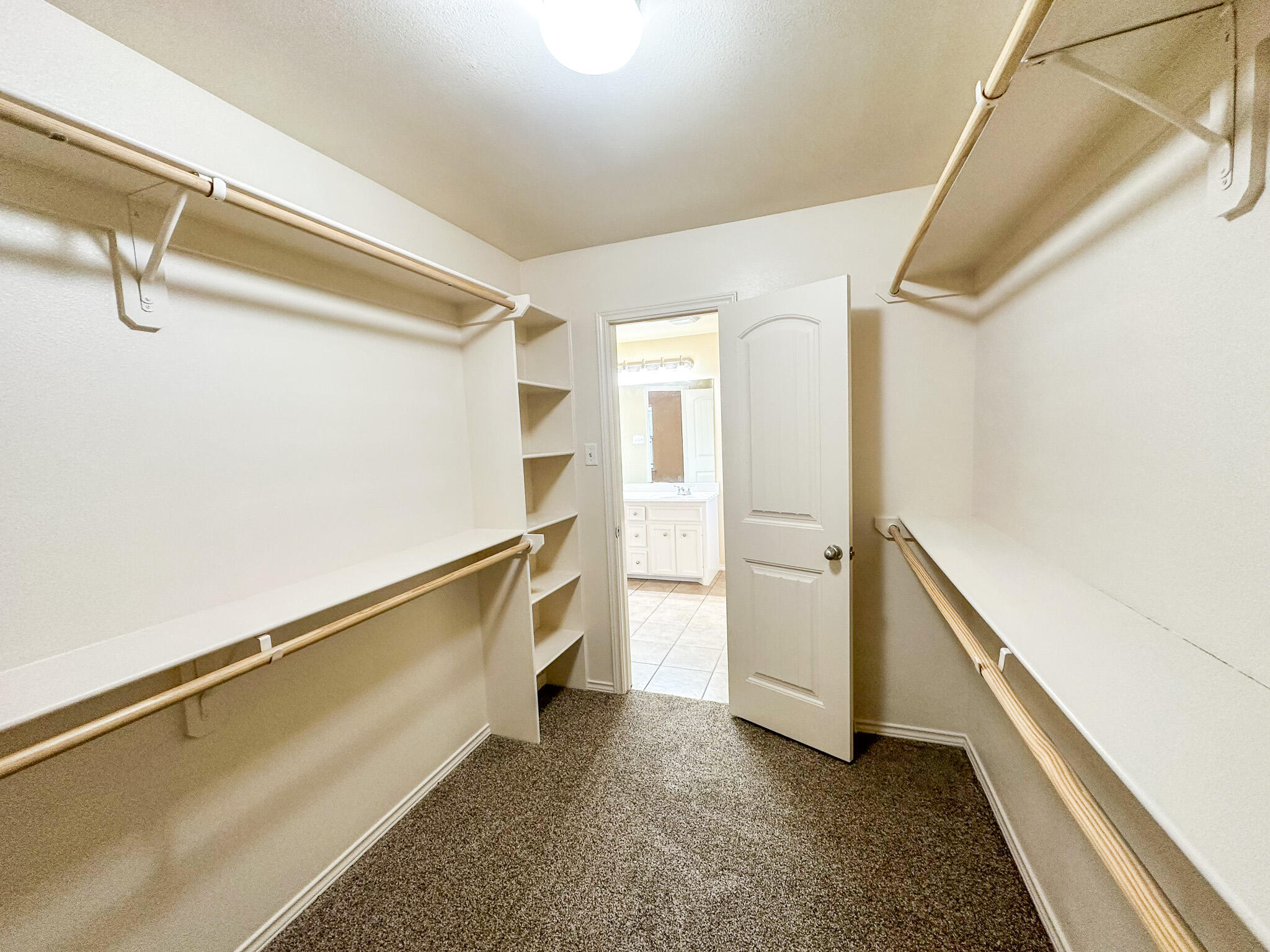 2309 101st Street Lubbock, TX 79423 - Photo 23 of 36 a view of an empty walk in closet