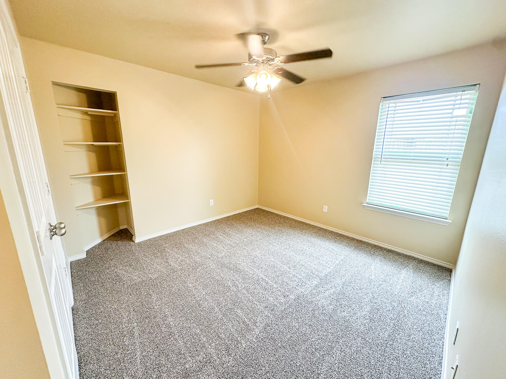 2309 101st Street Lubbock, TX 79423 - Photo 31 of 36 an empty room with a empty space and a ceiling fan
