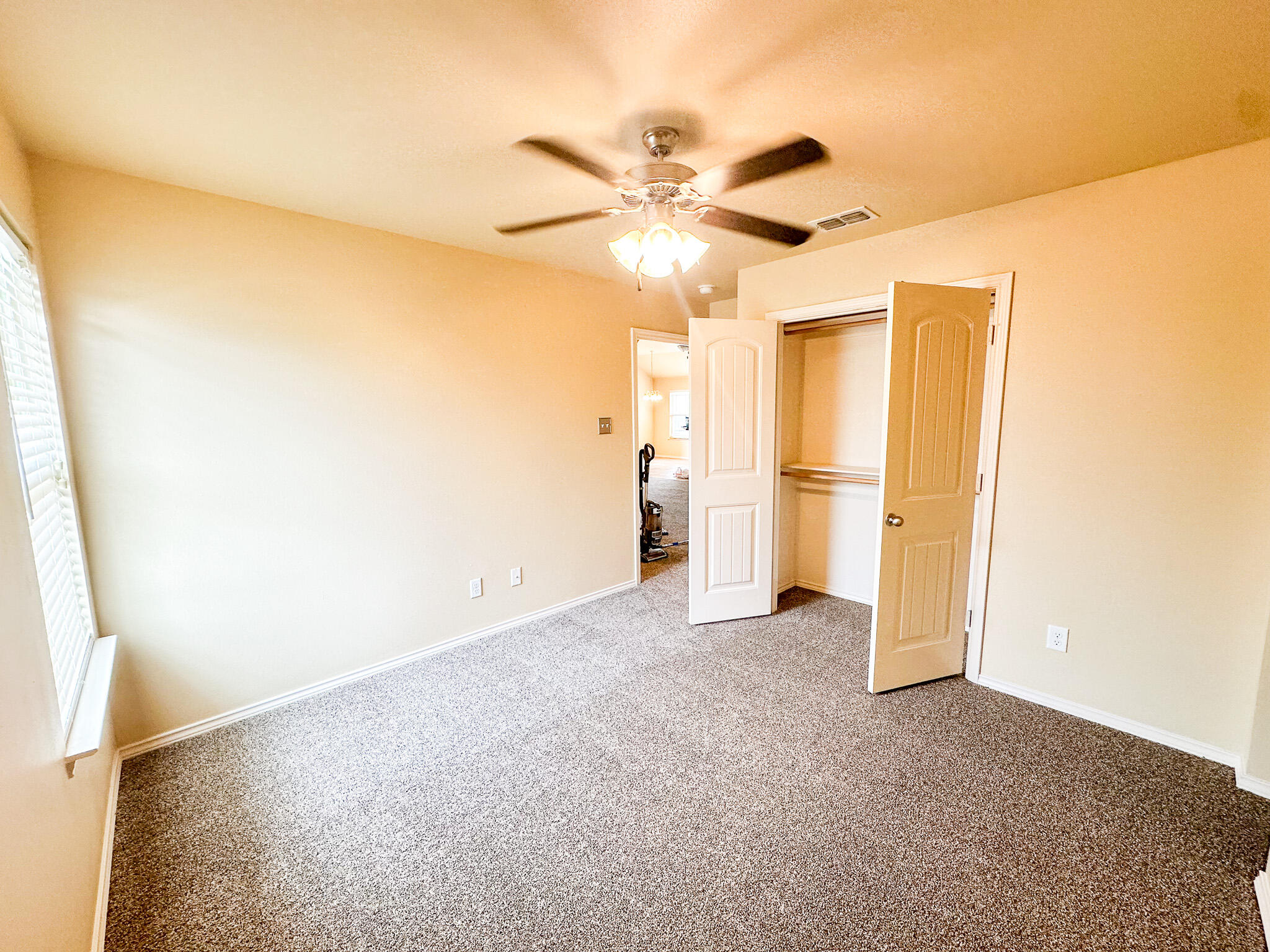 2309 101st Street Lubbock, TX 79423 - Photo 33 of 36 an empty room with closet and a ceiling fan