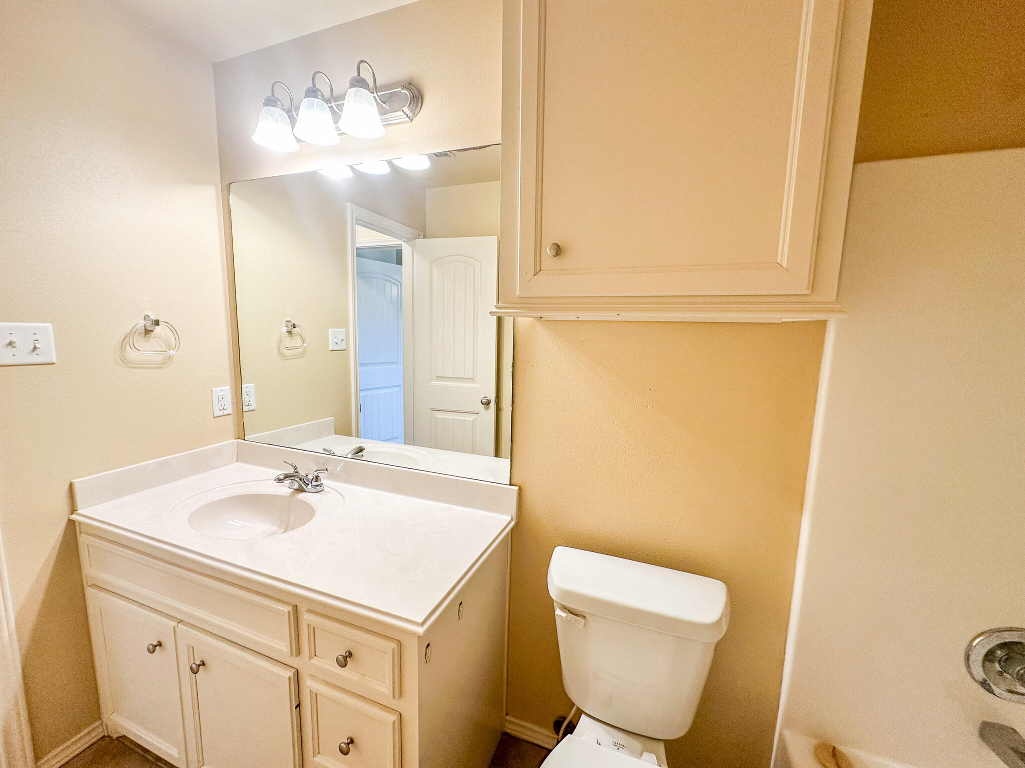 2309 101st Street Lubbock, TX 79423 - Photo 34 of 36 a bathroom with a sink and a mirror