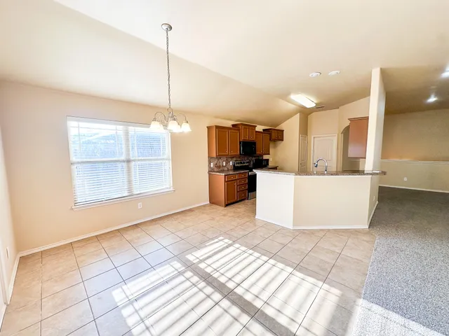 a view of a kitchen with a sink and a window