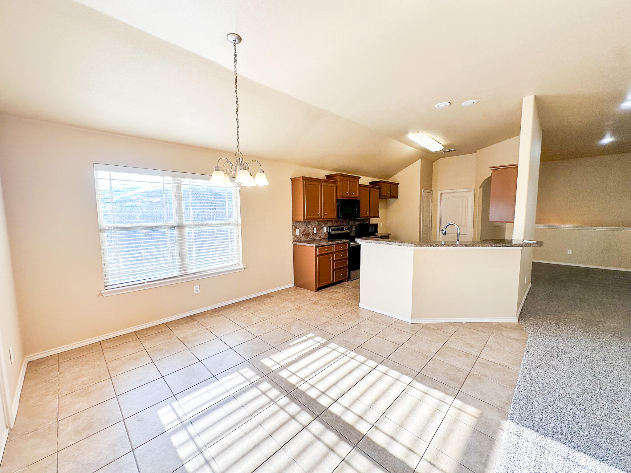 2309 101st Street Lubbock, TX 79423 - Photo 8 of 36 a view of a kitchen with a sink and a window