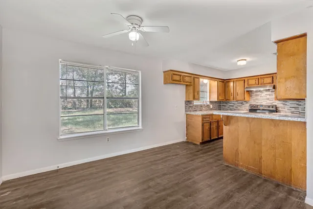 a view of empty room with wooden floor