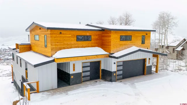a view of a house with a wooden fence