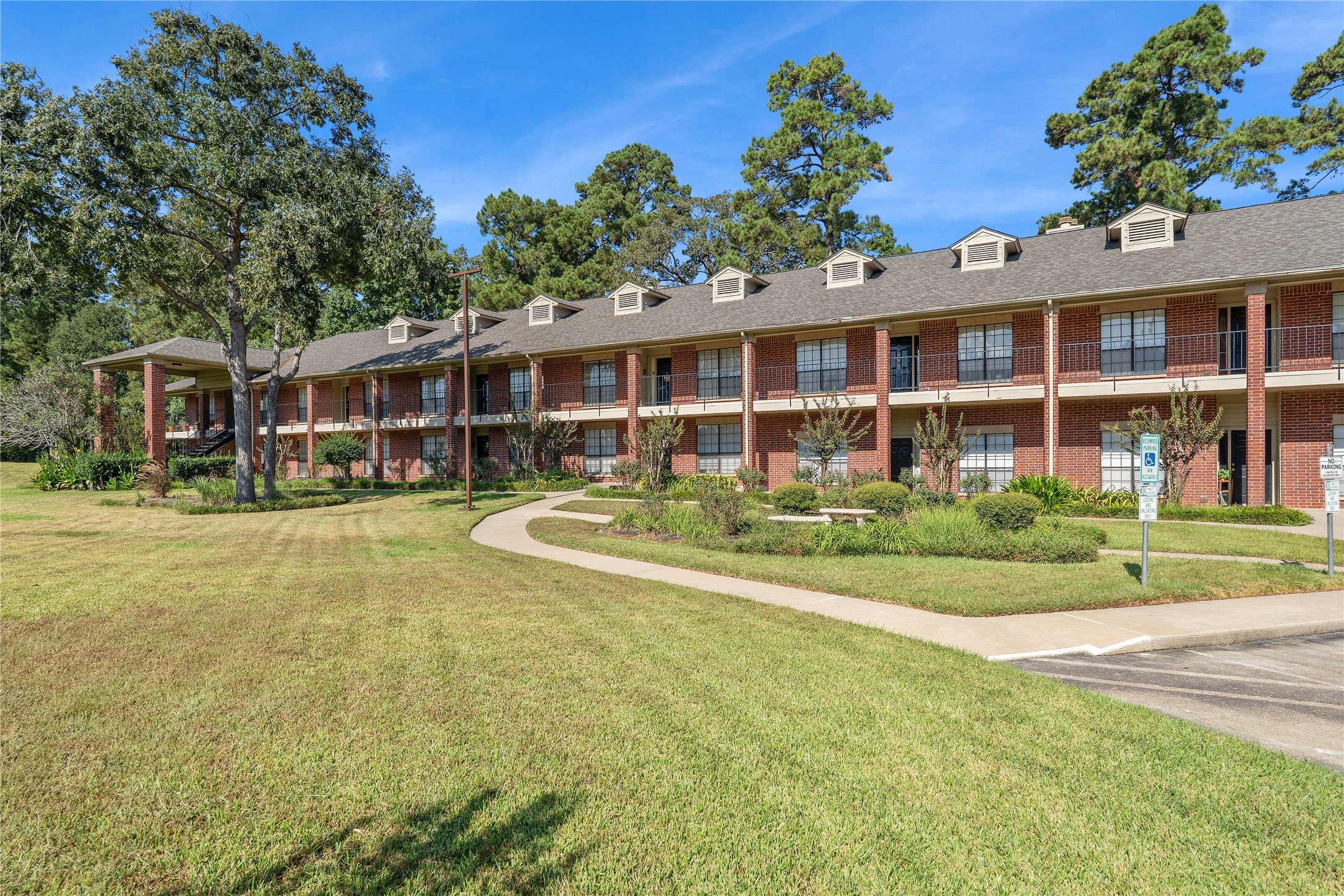 200 Panorama Drive, Unit 107 Conroe, TX 77304 - Photo 1 of 32 a front view of a house with a yard table and chairs