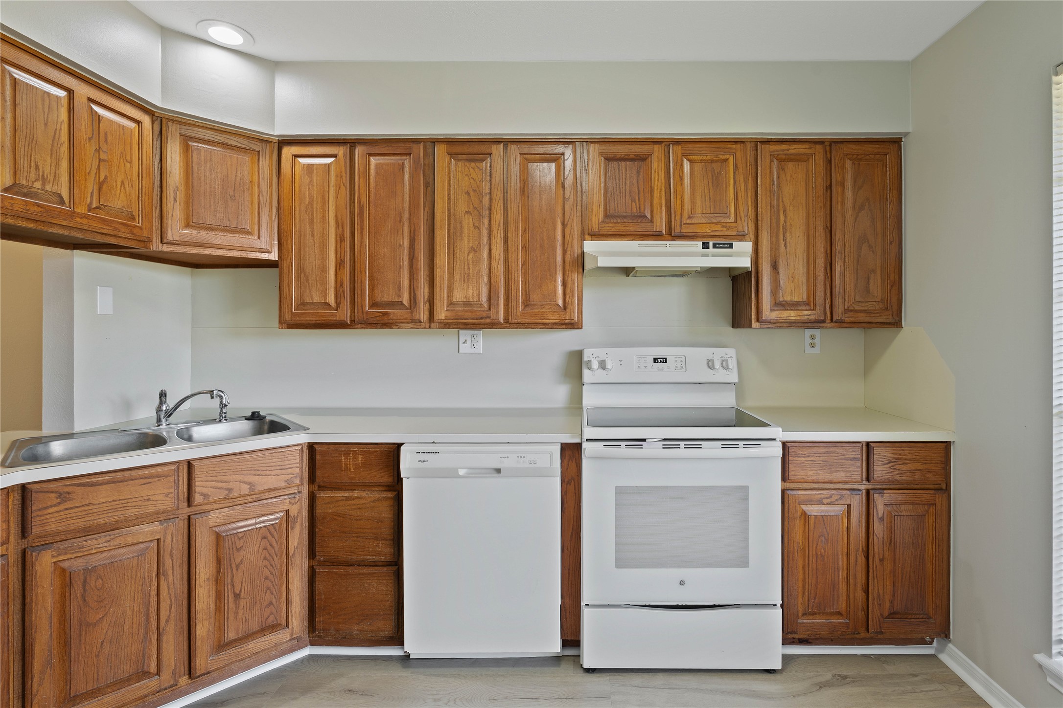 200 Panorama Drive, Unit 107 Conroe, TX 77304 - Photo 12 of 32 a kitchen with stainless steel appliances granite countertop a stove and a sink