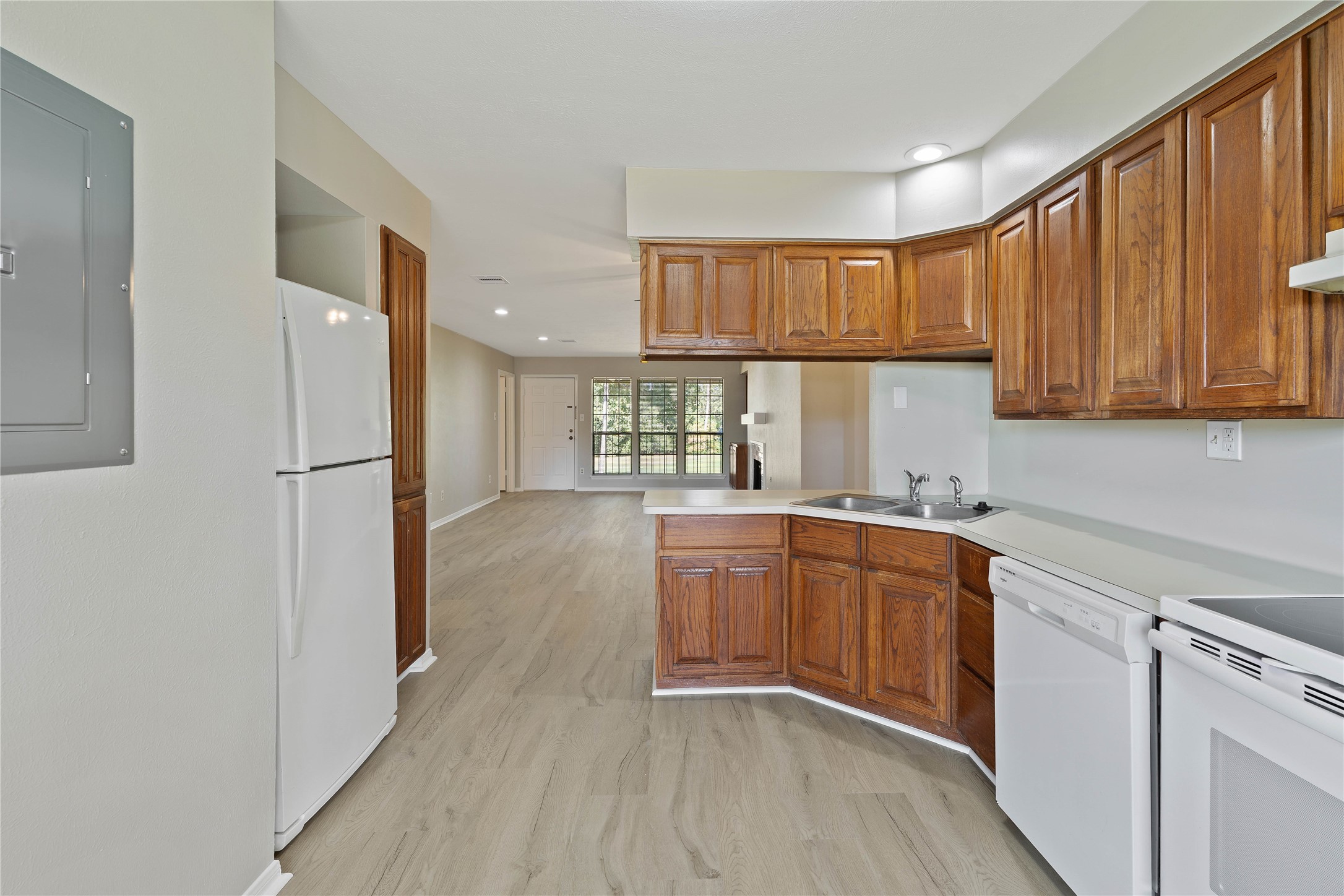 200 Panorama Drive, Unit 107 Conroe, TX 77304 - Photo 14 of 32 a kitchen with stainless steel appliances granite countertop a refrigerator sink and cabinets
