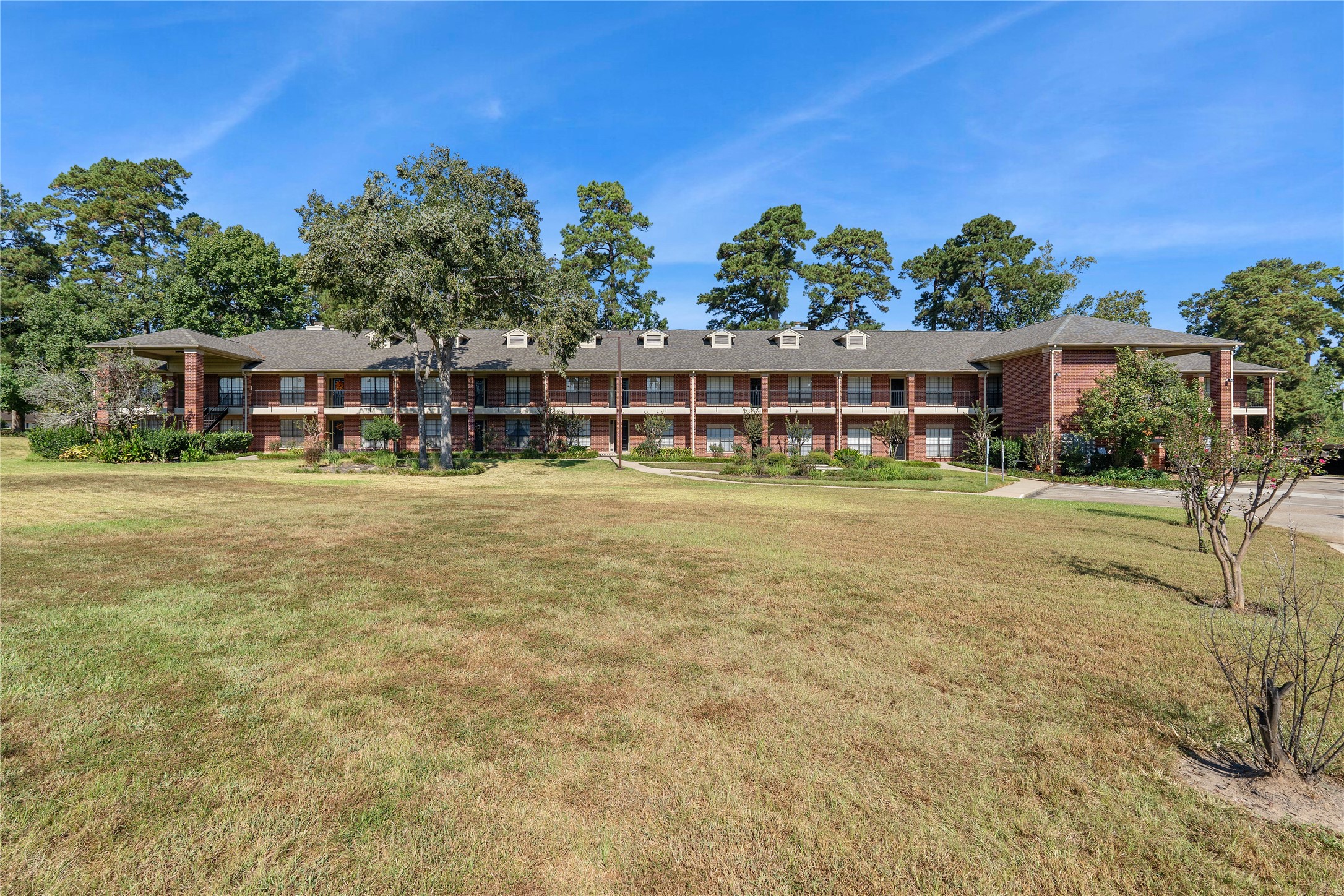 200 Panorama Drive, Unit 107 Conroe, TX 77304 - Photo 2 of 32 a view of a house with outdoor space and sitting space