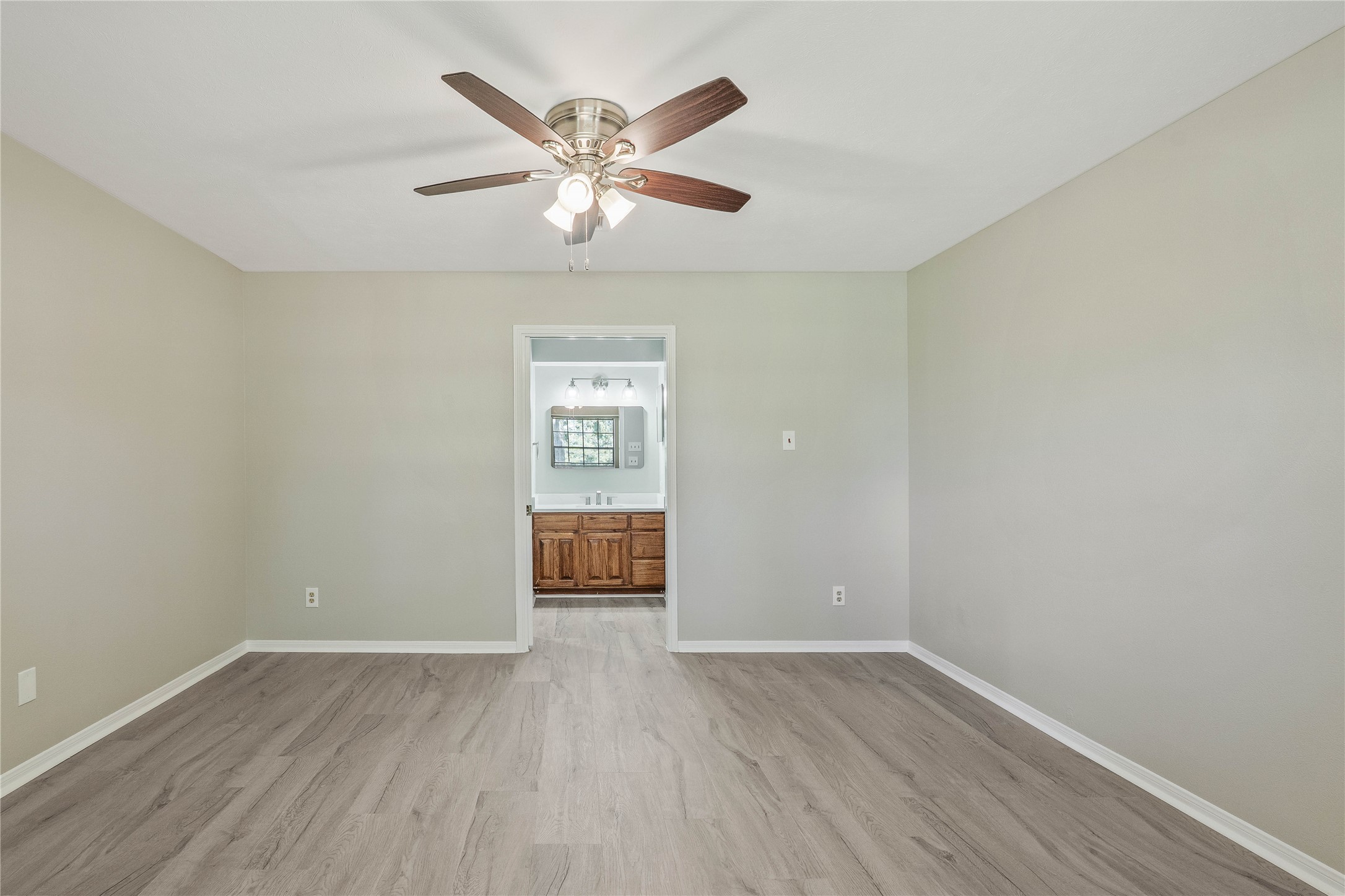 200 Panorama Drive, Unit 107 Conroe, TX 77304 - Photo 21 of 32 wooden floor in an empty room with a window